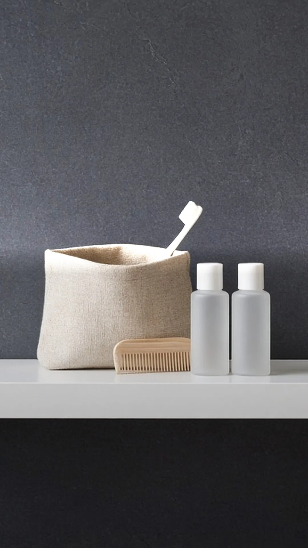 An open toiletry pouch with a toothbrush, a comb, and small blank bottles